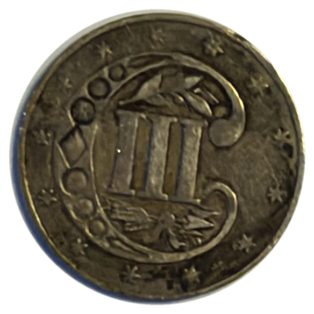 1860 three-cent silver piece, back: Roman numeral III inside an ornamental C
